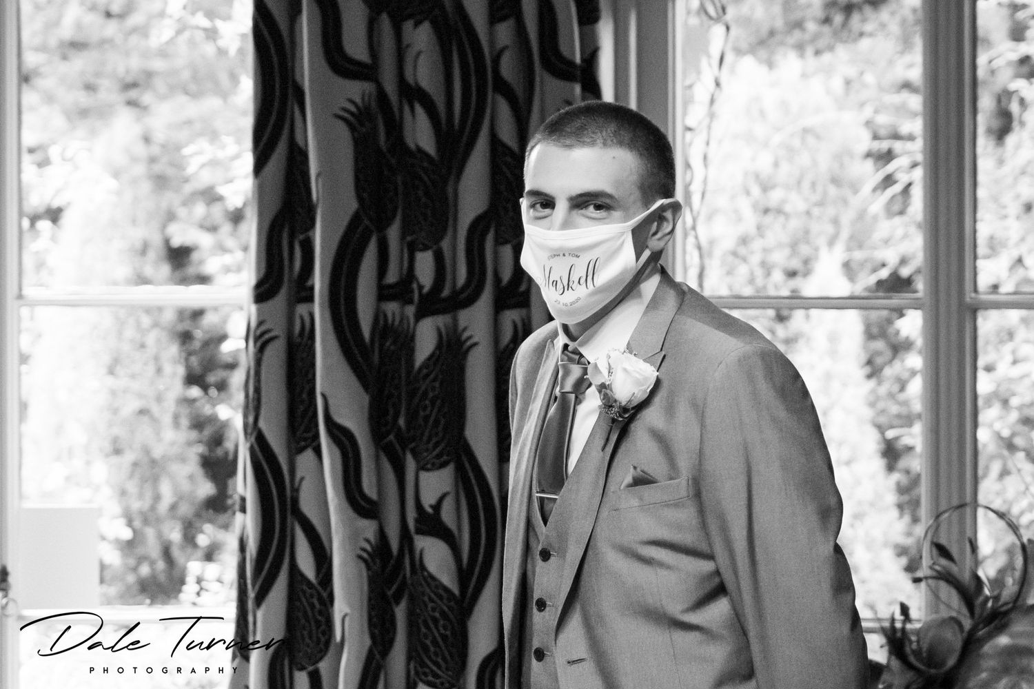 Groom on wedding day wearing a Covid face mask