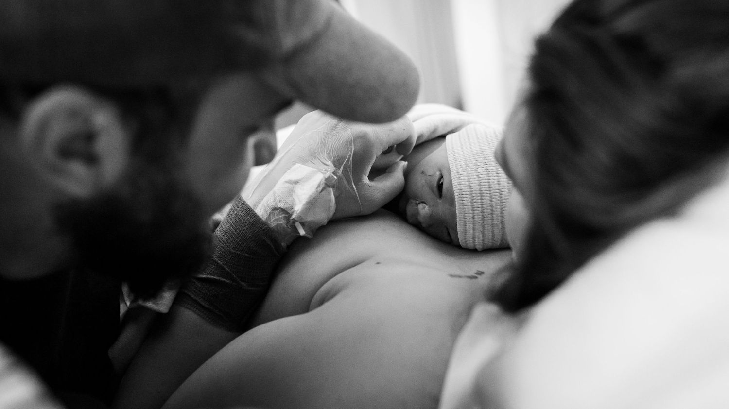 New parents gaze at their brand new baby moments after his Longmont, CO birth