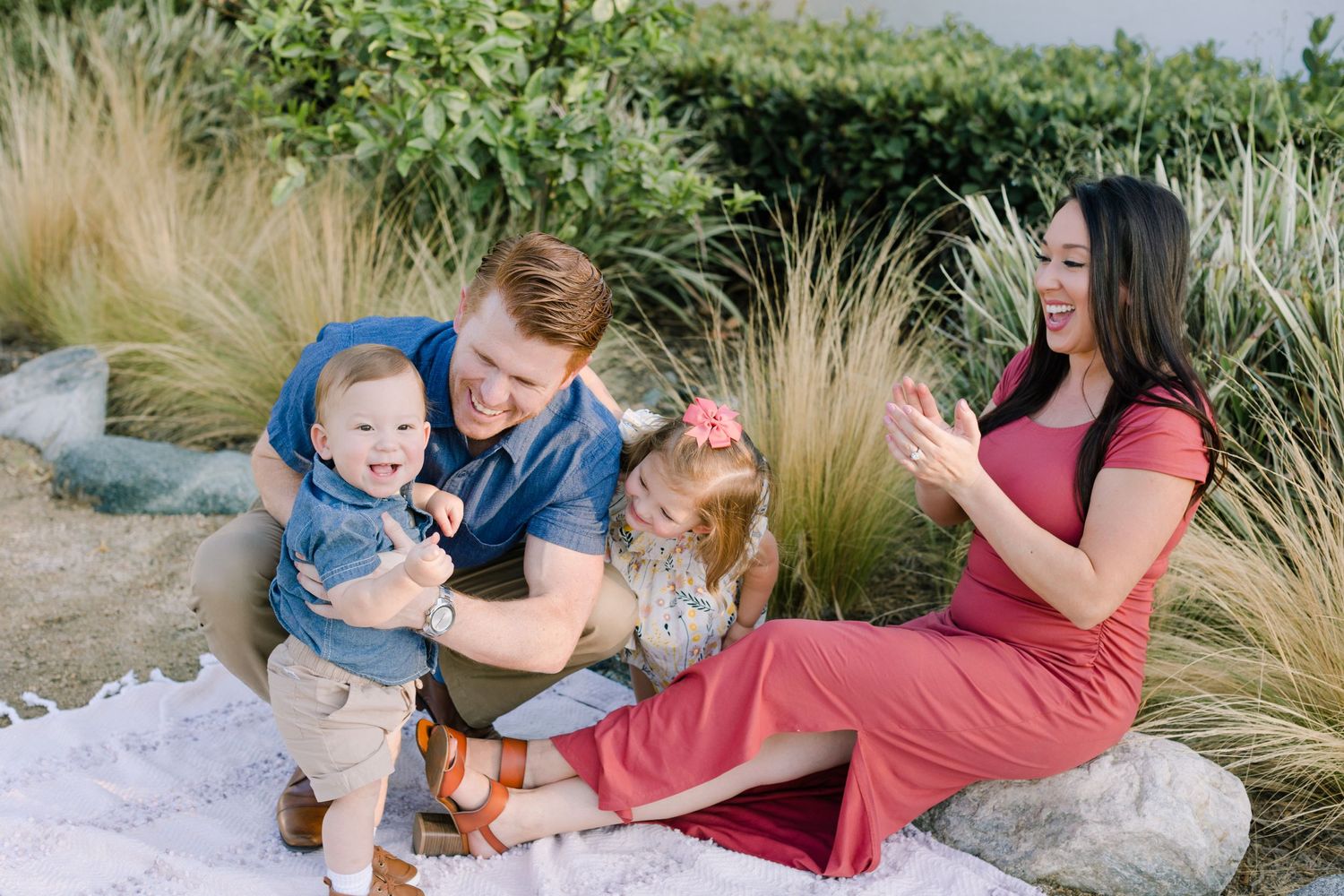 smiling little boy just walking mom dad sister cheering