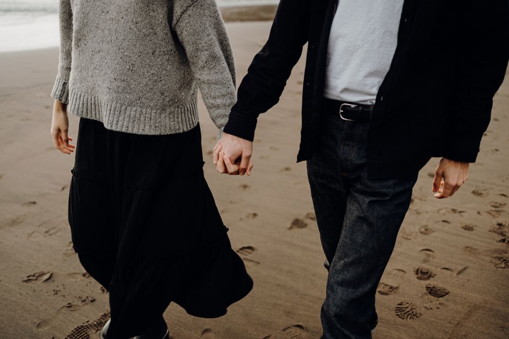 Couple strolling in Piha for their engagement shoot with Apertured Media-Auckland Wedding and Engagement Photographer