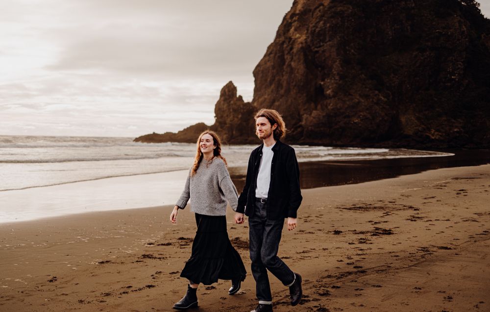 Lovers walking in Piha for their engagement shoot with Apertured Media-Auckland Wedding and Engagement Photographer