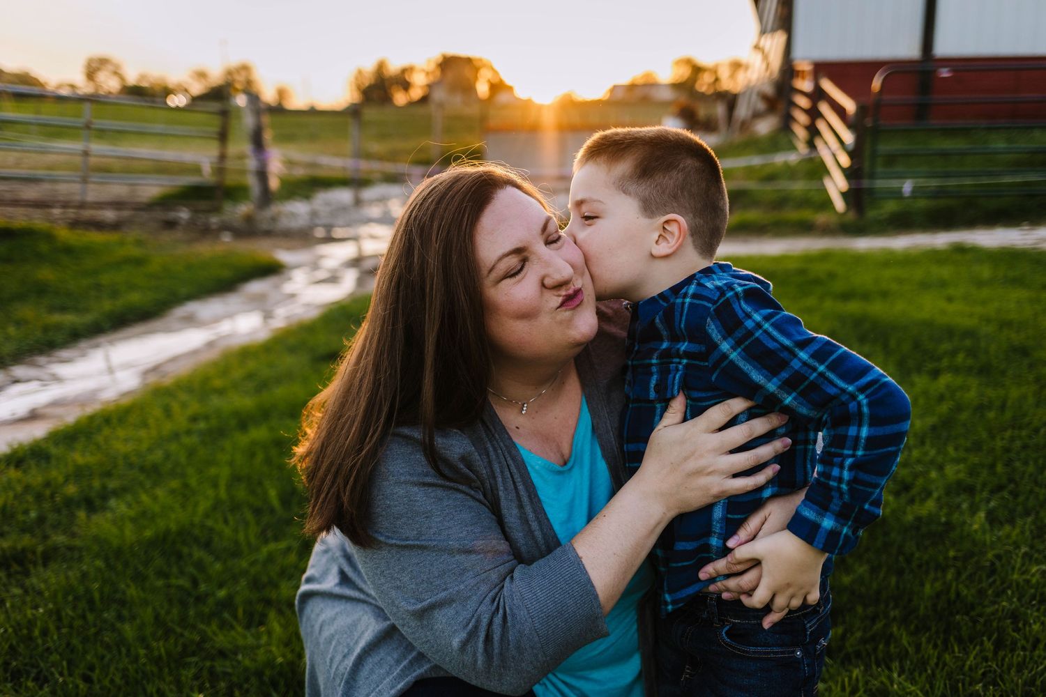 Golden hour photo take of son giving mom kisses at cozy nook farm wales wisconsin