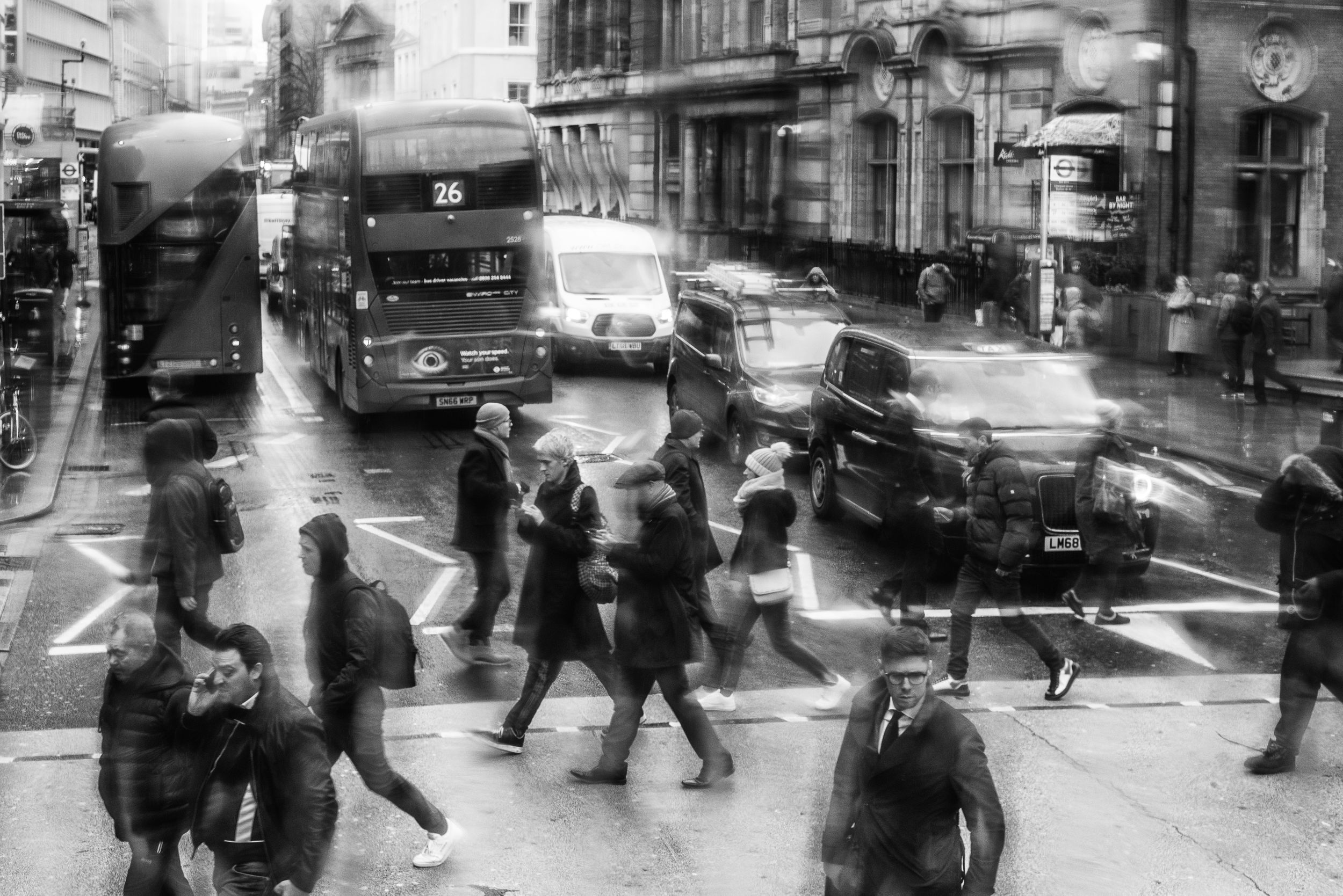 Black and white image of people crossing the street in London
