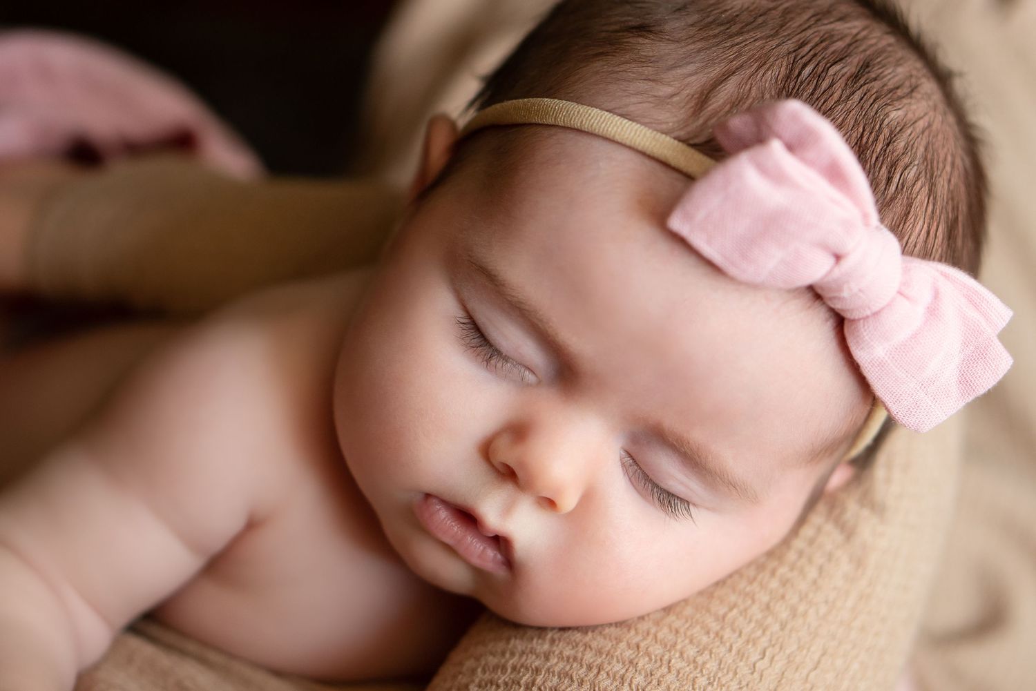 baby sleeps in mother's arms