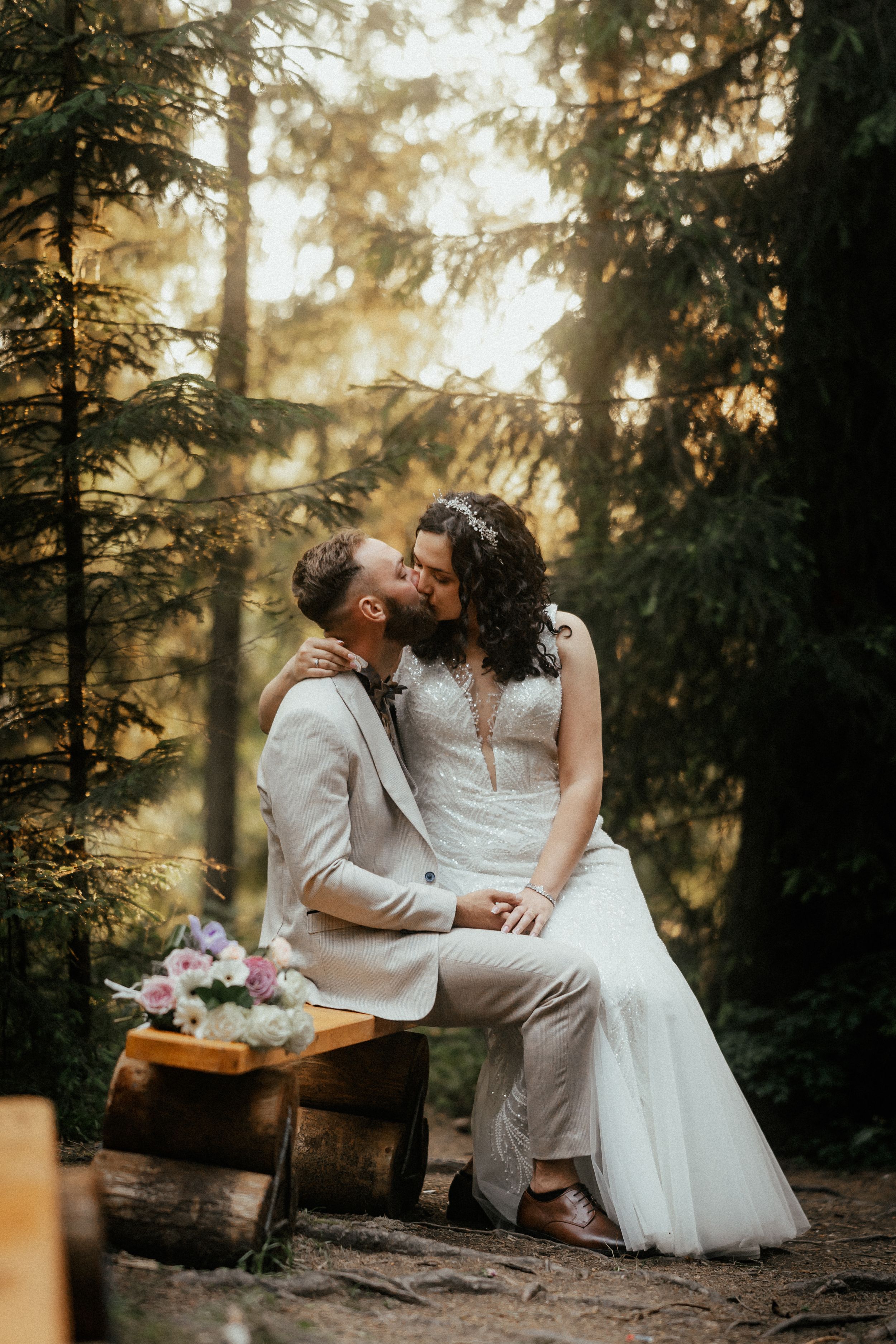 Romantic portrait of the newlyweds against a stunning sunset backdrop.