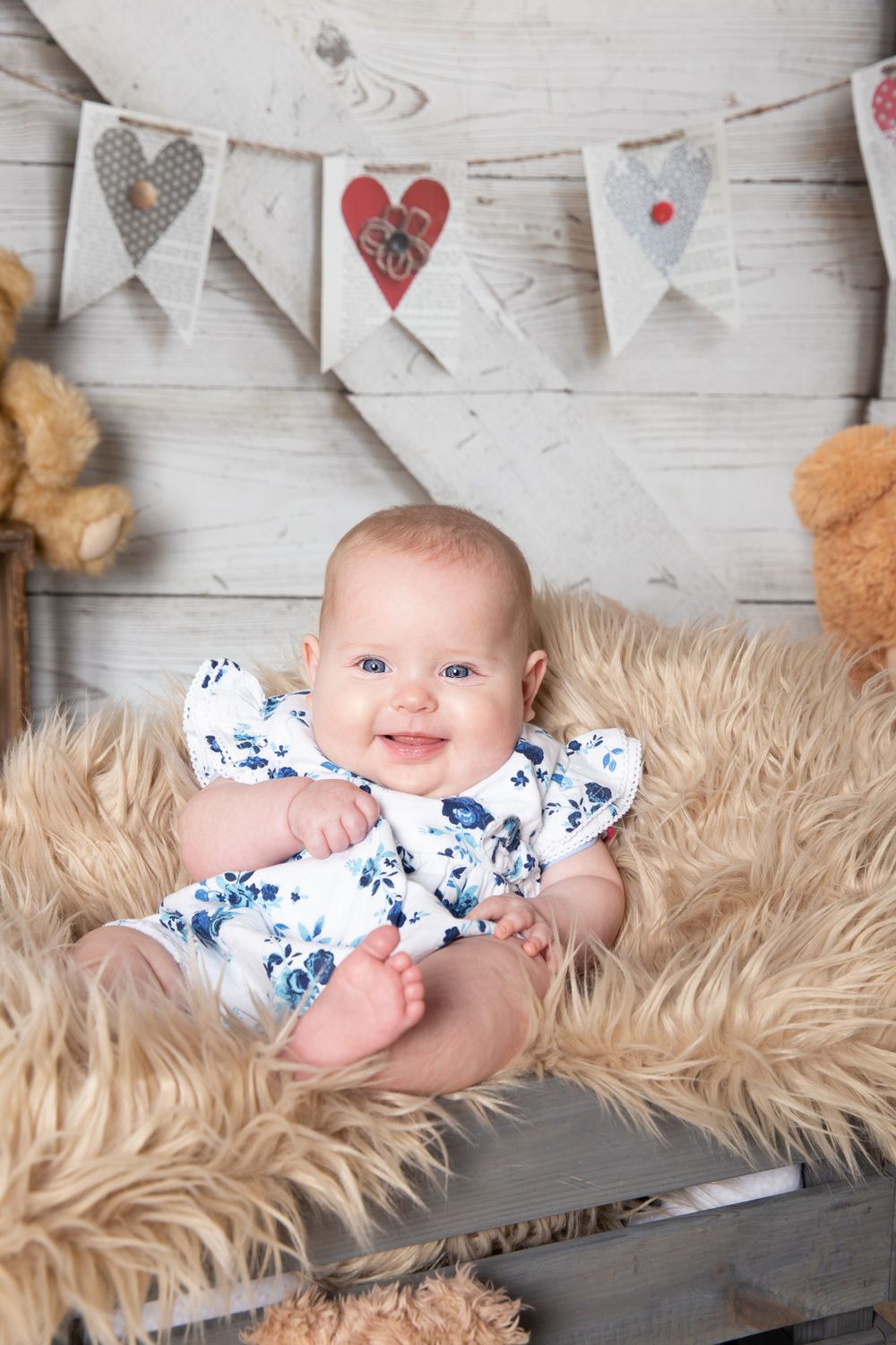 baby in a crate smiling