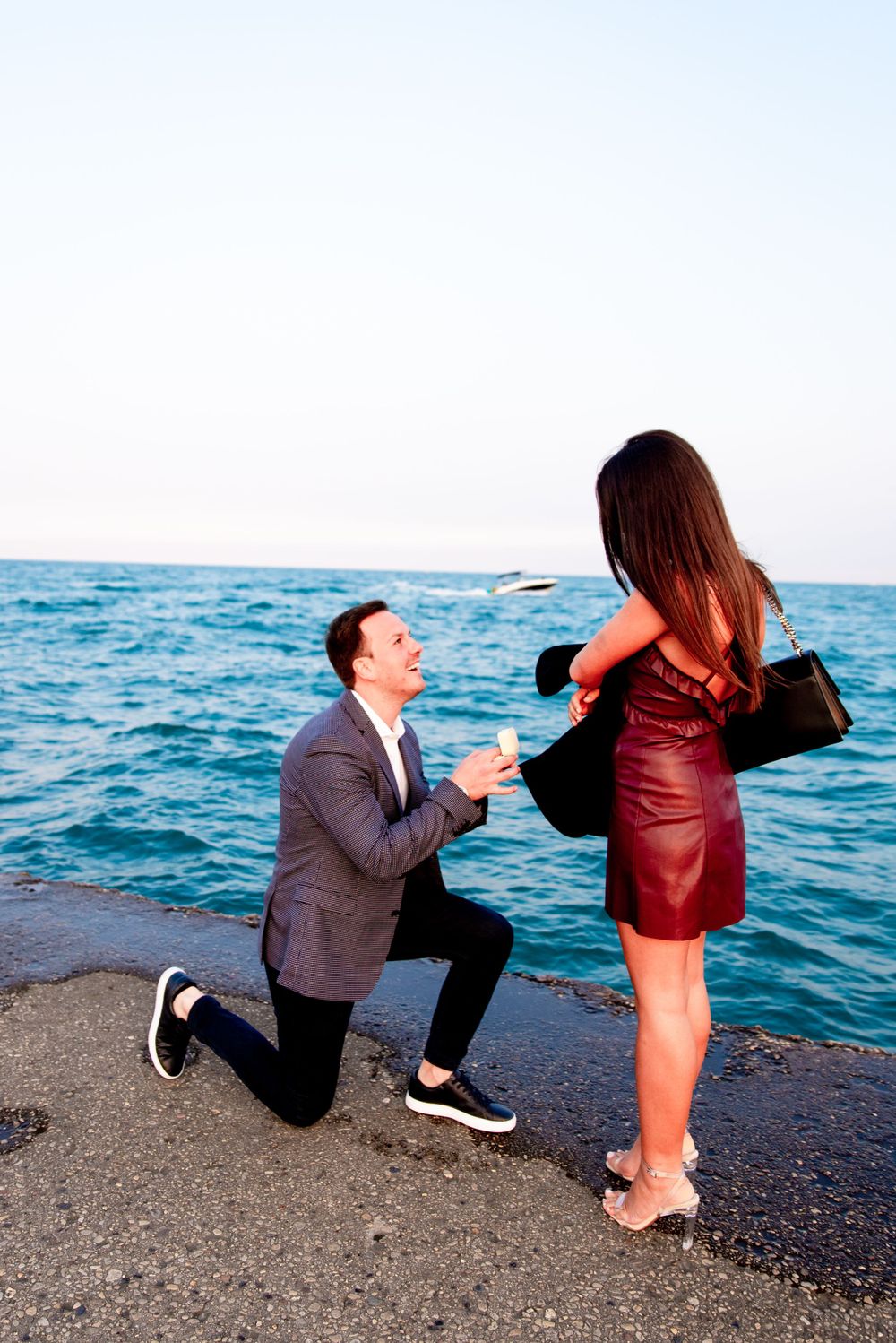 man in gray suit down on one knee for North Avenue Beach Chicago proposal