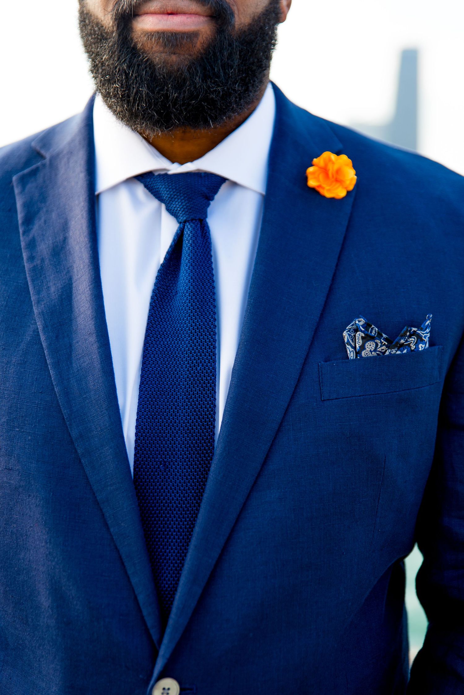 man in navy suit with orange flower boutonniere for Chicago sunrise elopement