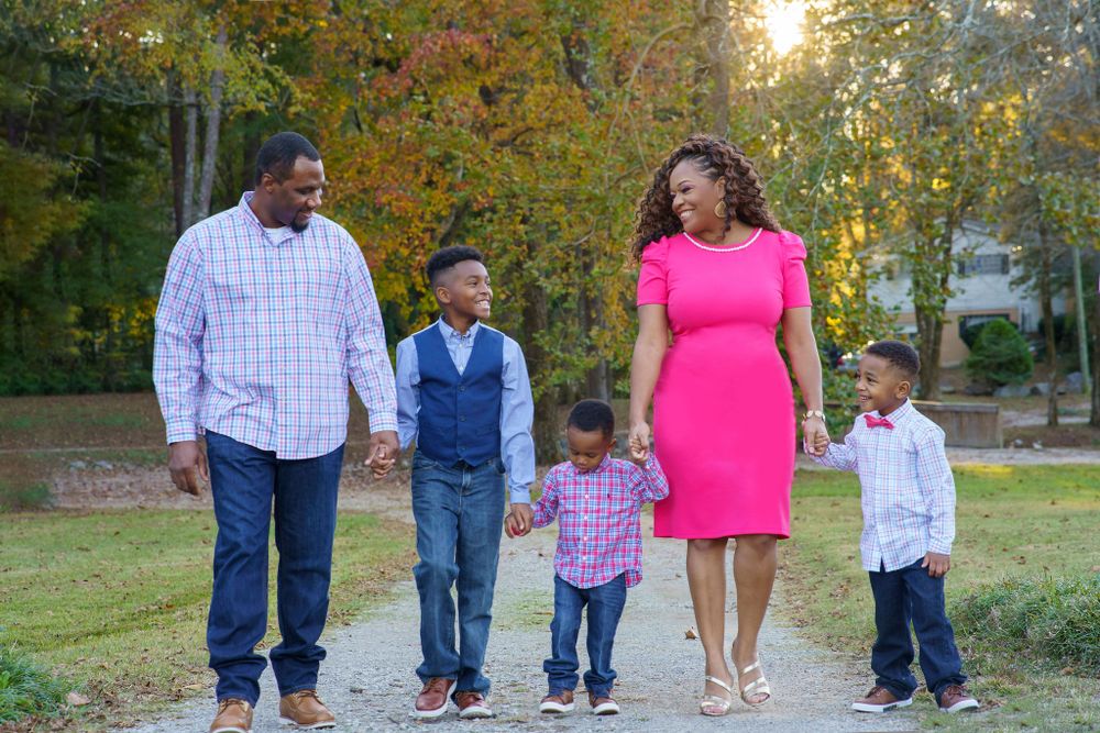 family of five+ walking+ smiling+ in park