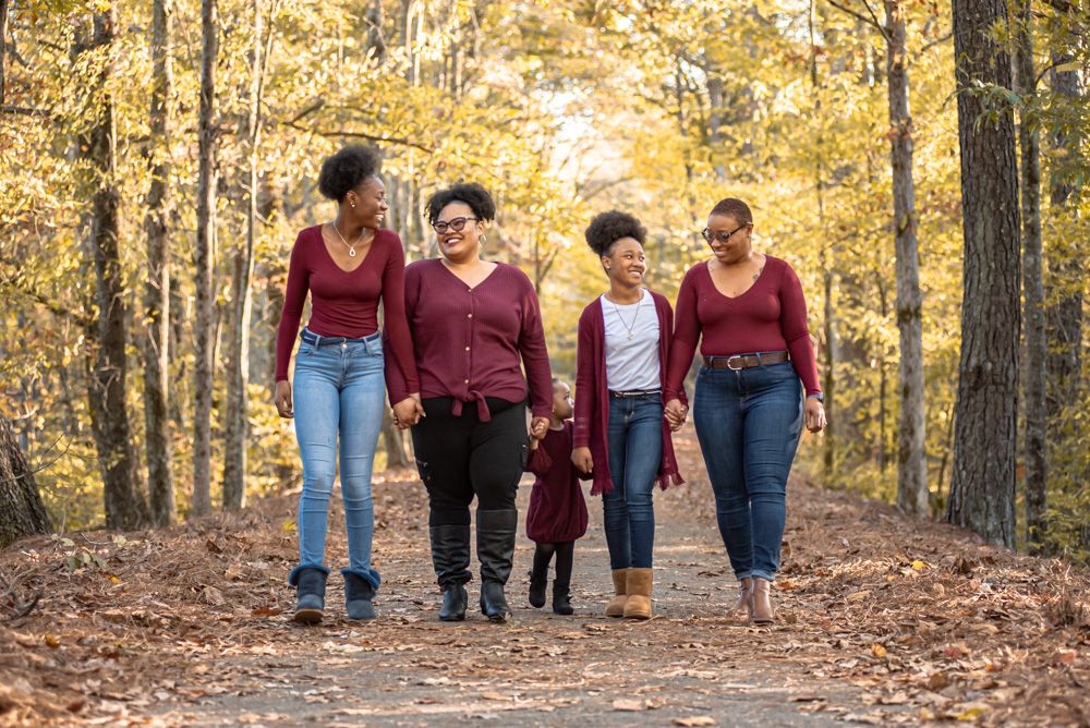 Sisters walk and talk on leafy path + fall photography ideas + fall colors + fall photo ideas