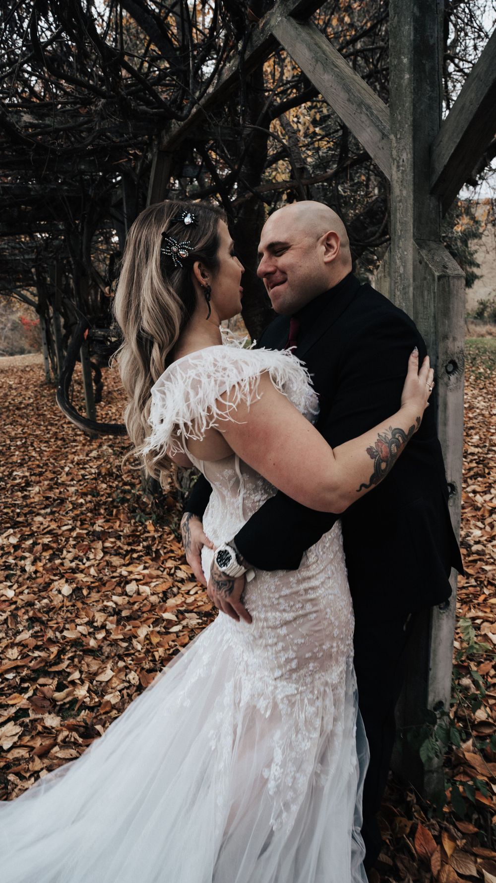 Groom pulling his bride in and they are smiling
