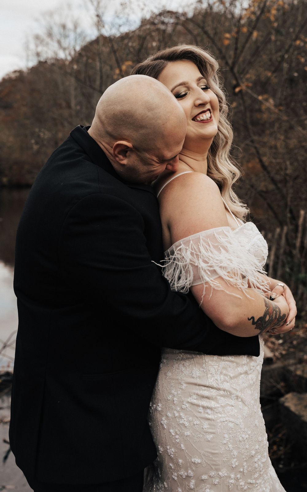 groom kissing the neck of his bride at Waterloo Villiage