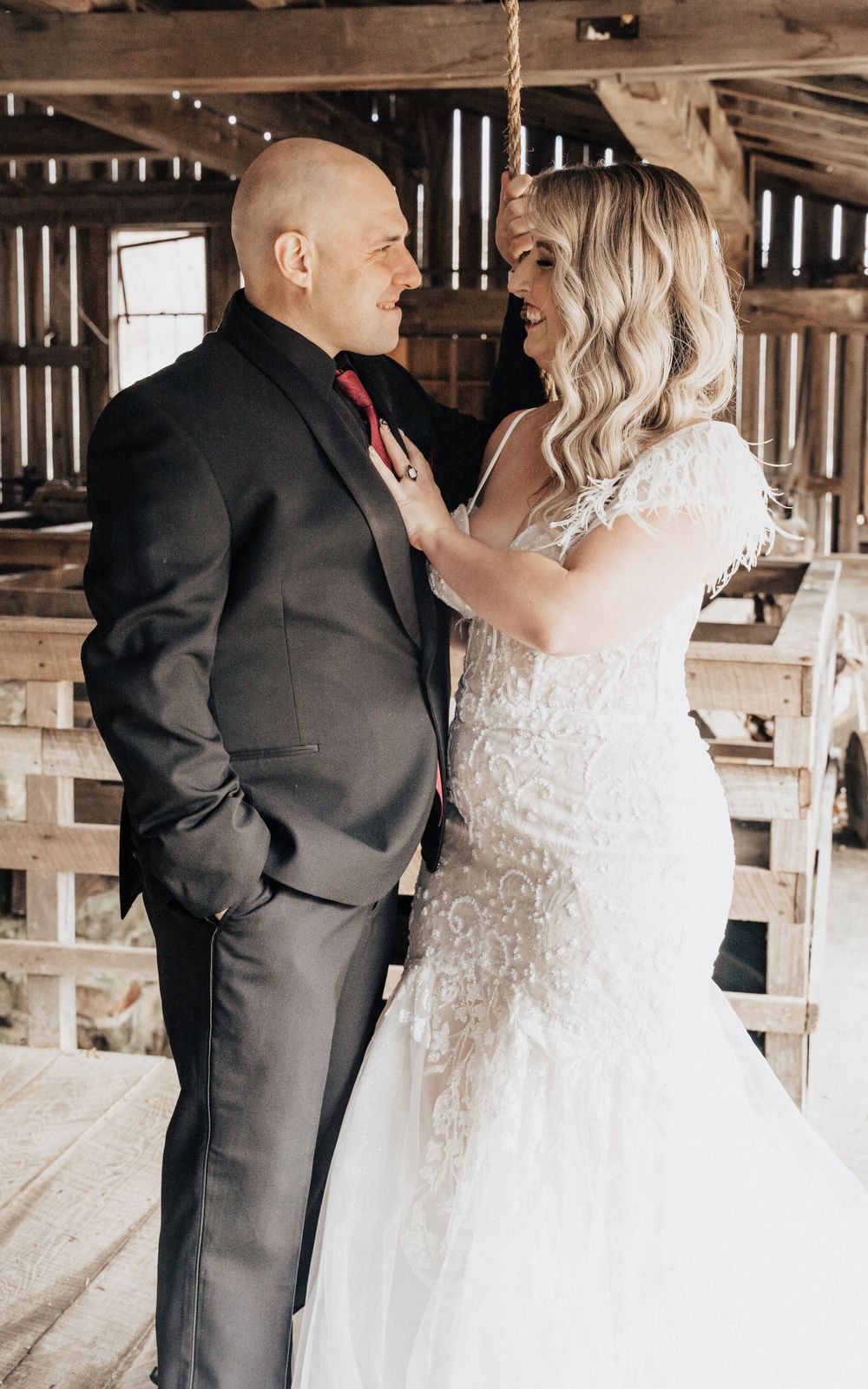 bride and groom looking at each other smiling her hands on her husbands chest