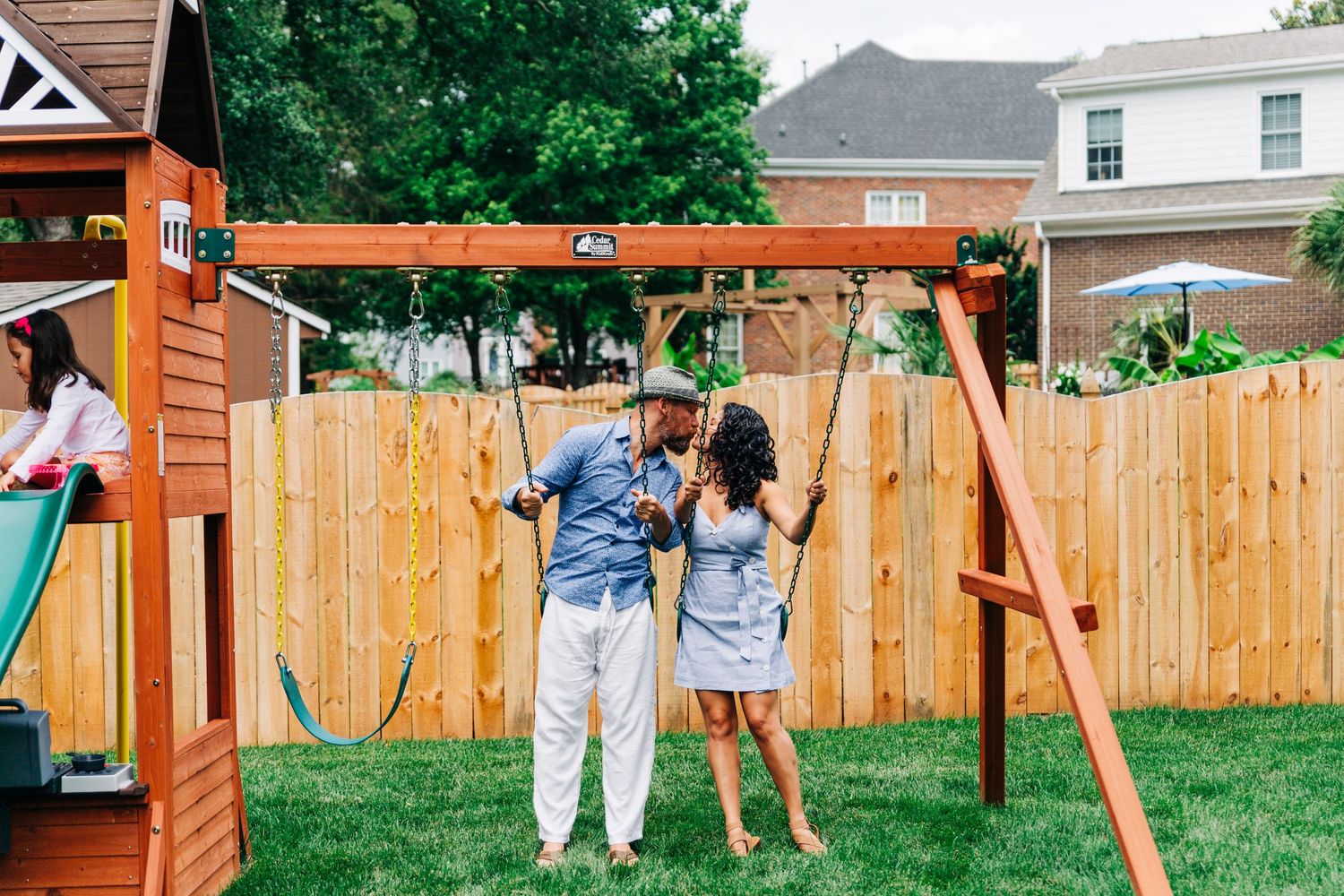 Parents kissing on swing set during Charlotte family photos