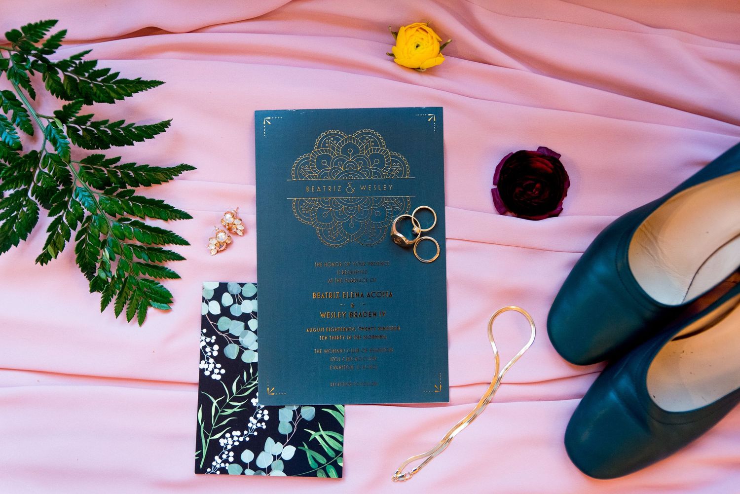 green wedding shoes and invitations on a blush pink dress