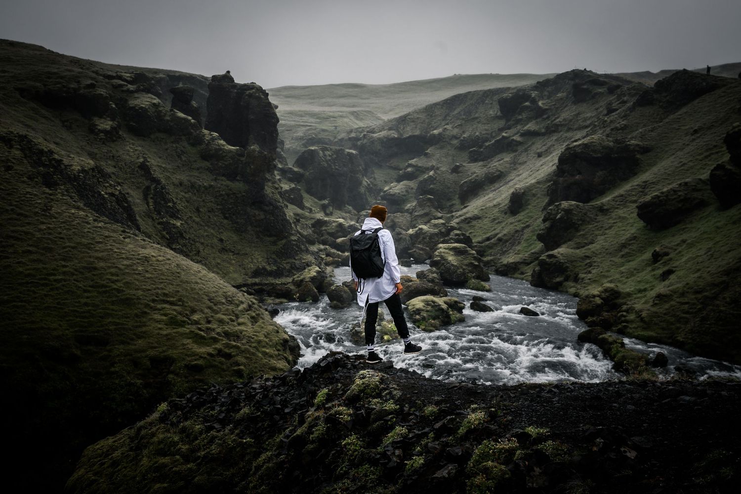 photographer and artist skywalker zain onlooking a tumultuous river in Iceland. contact page photod