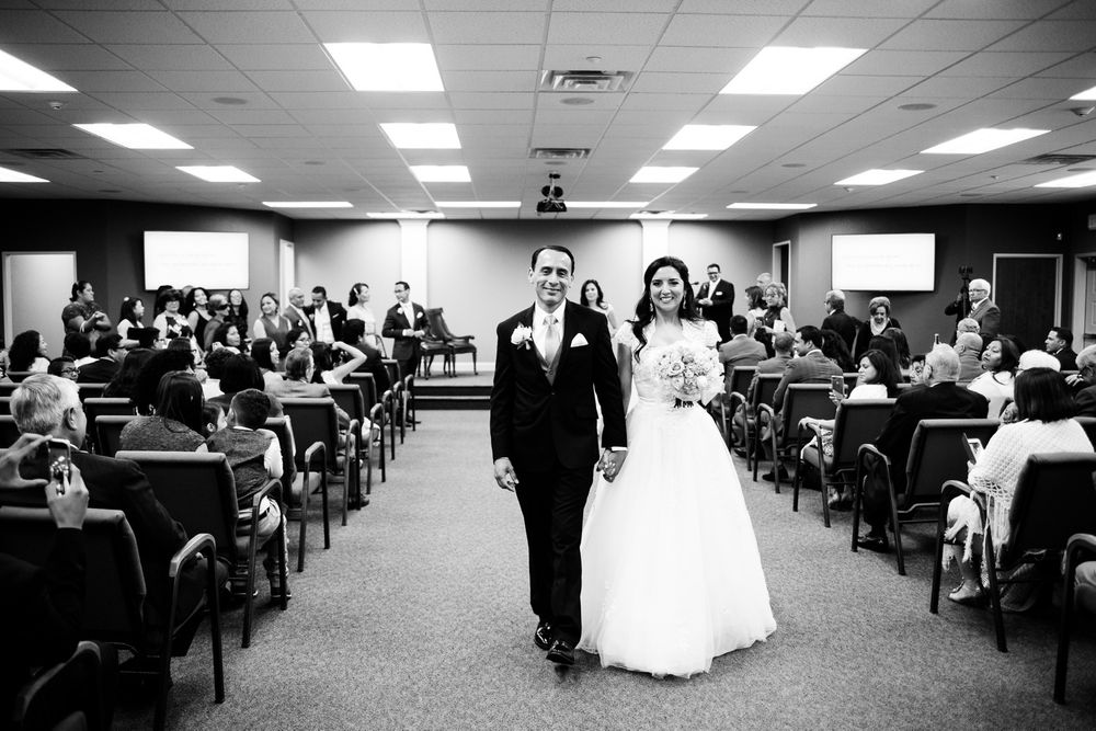 Bride and groom walk down aisle after wedding ceremony
