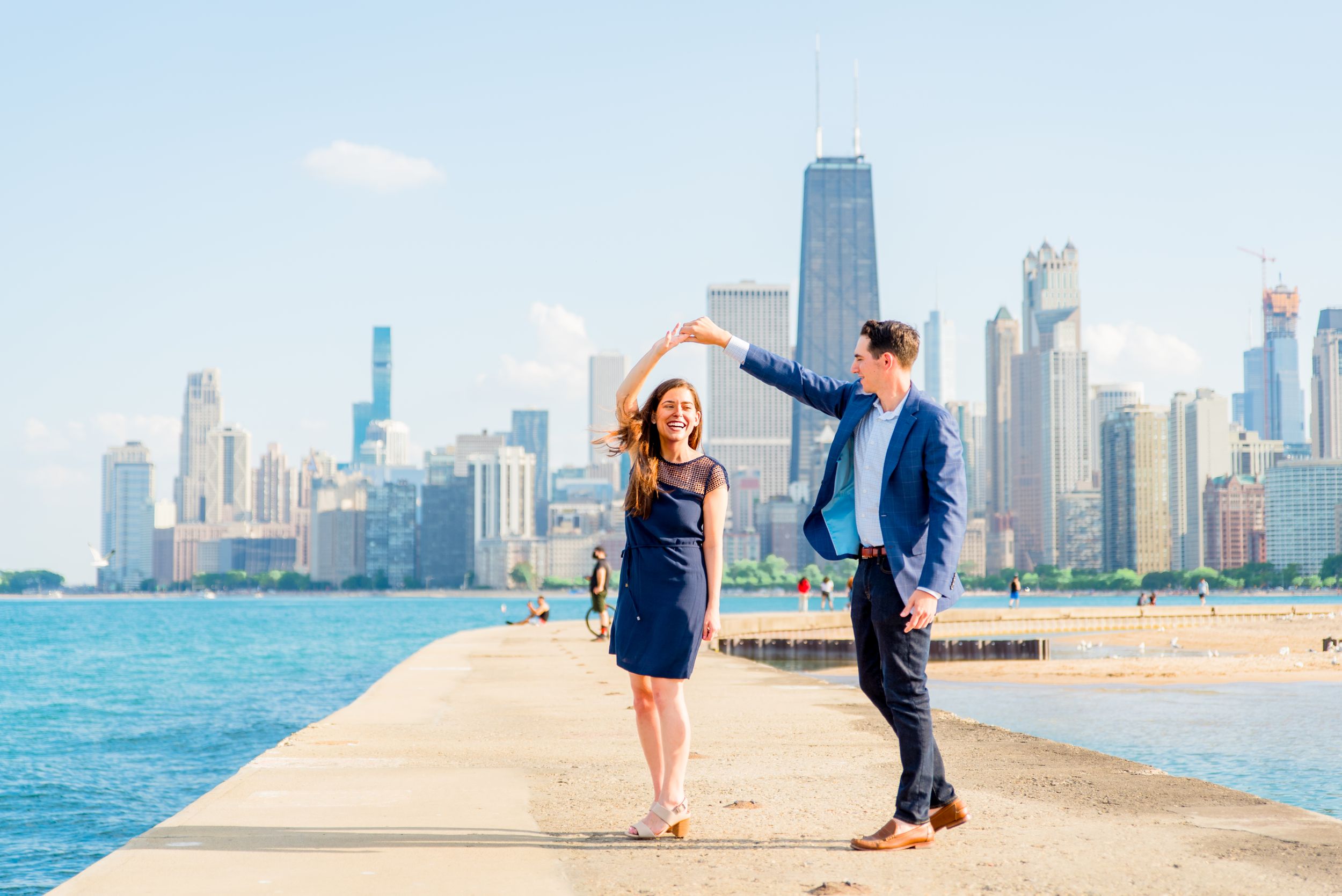 man and woman spinning in front of Hancock tower after North Avenue Beach proposal