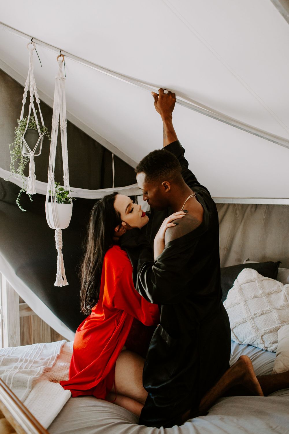 couple embracing on a bed during their intimate couples session