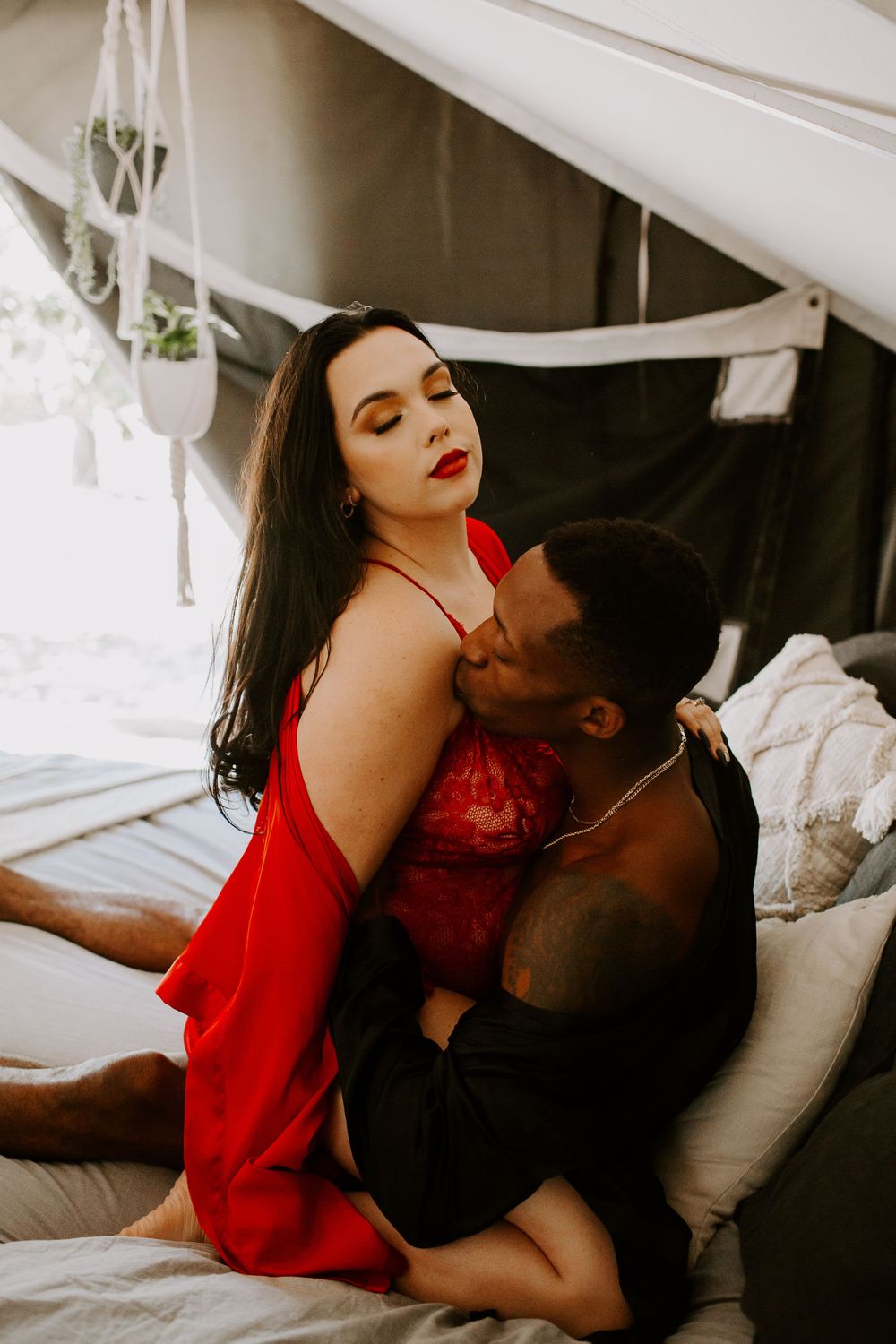 man kissing woman during their intimate couples boudoir session