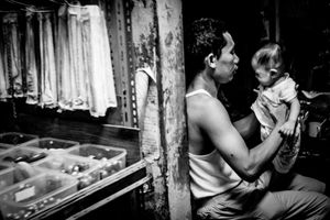 Black and white image of man and child in the Gloodok district of Jakarta Indonesia
