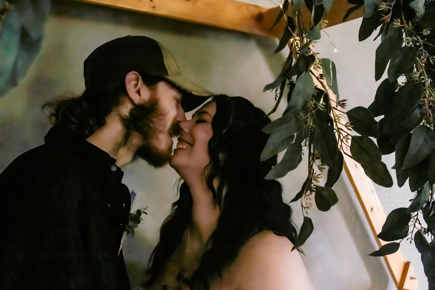 An intimate romantic moment shared between two people surrounded by greenery.