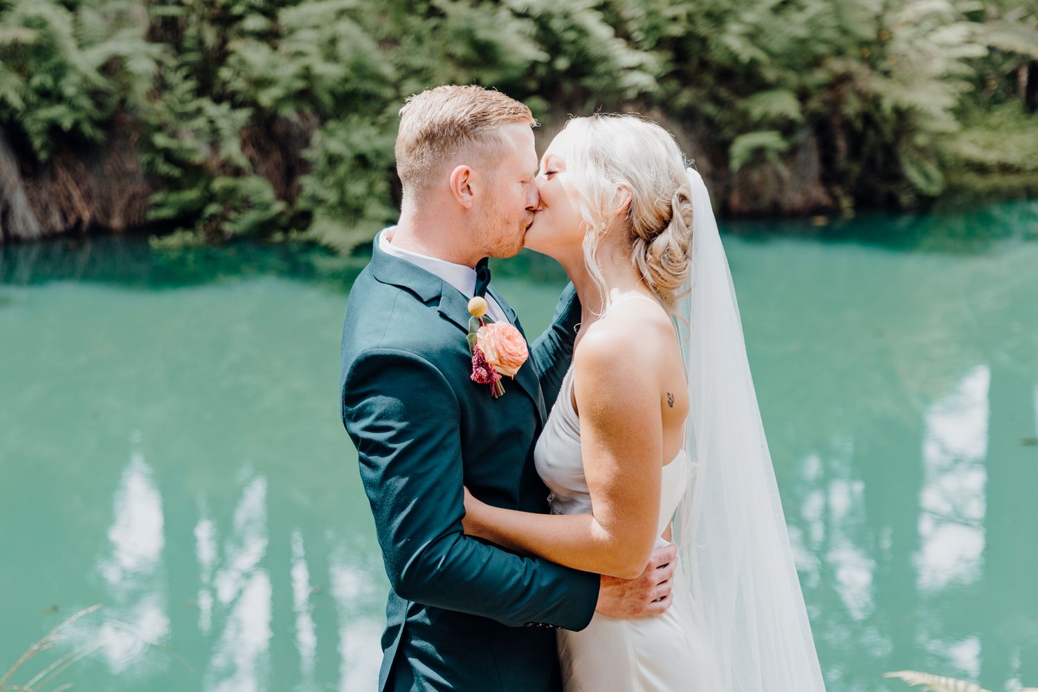 First kiss as a couple during a backyard wedding photoshoot with Apertured Media Auckland Wedding Photographer