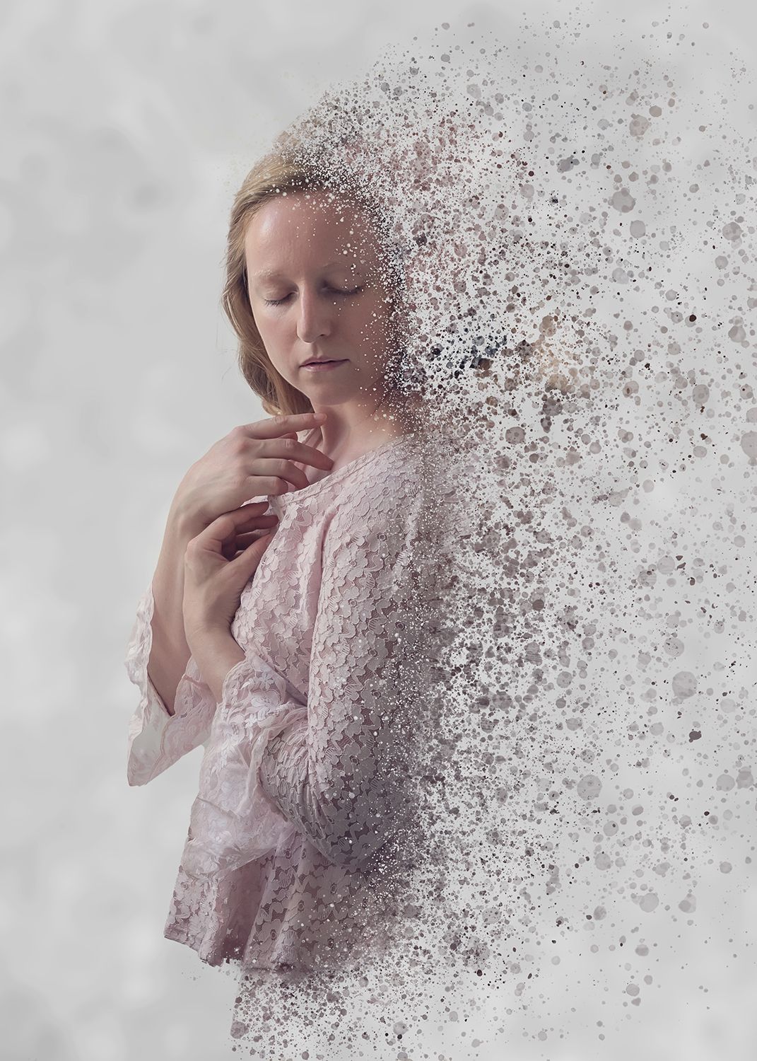 Portrait of a girl breaking up into dust