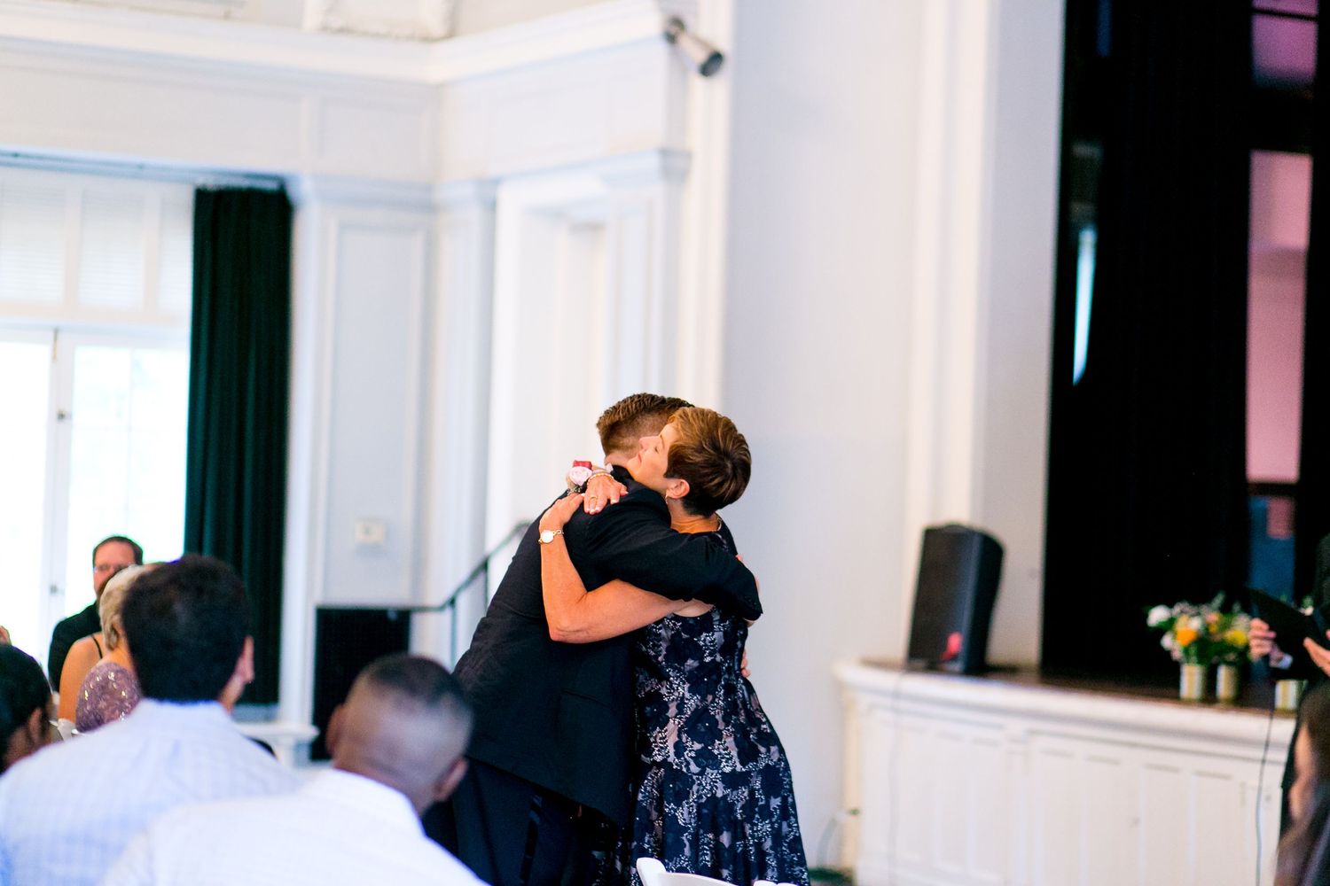 groom hugs his mother before he gets married at the Woman's Club of Evanston