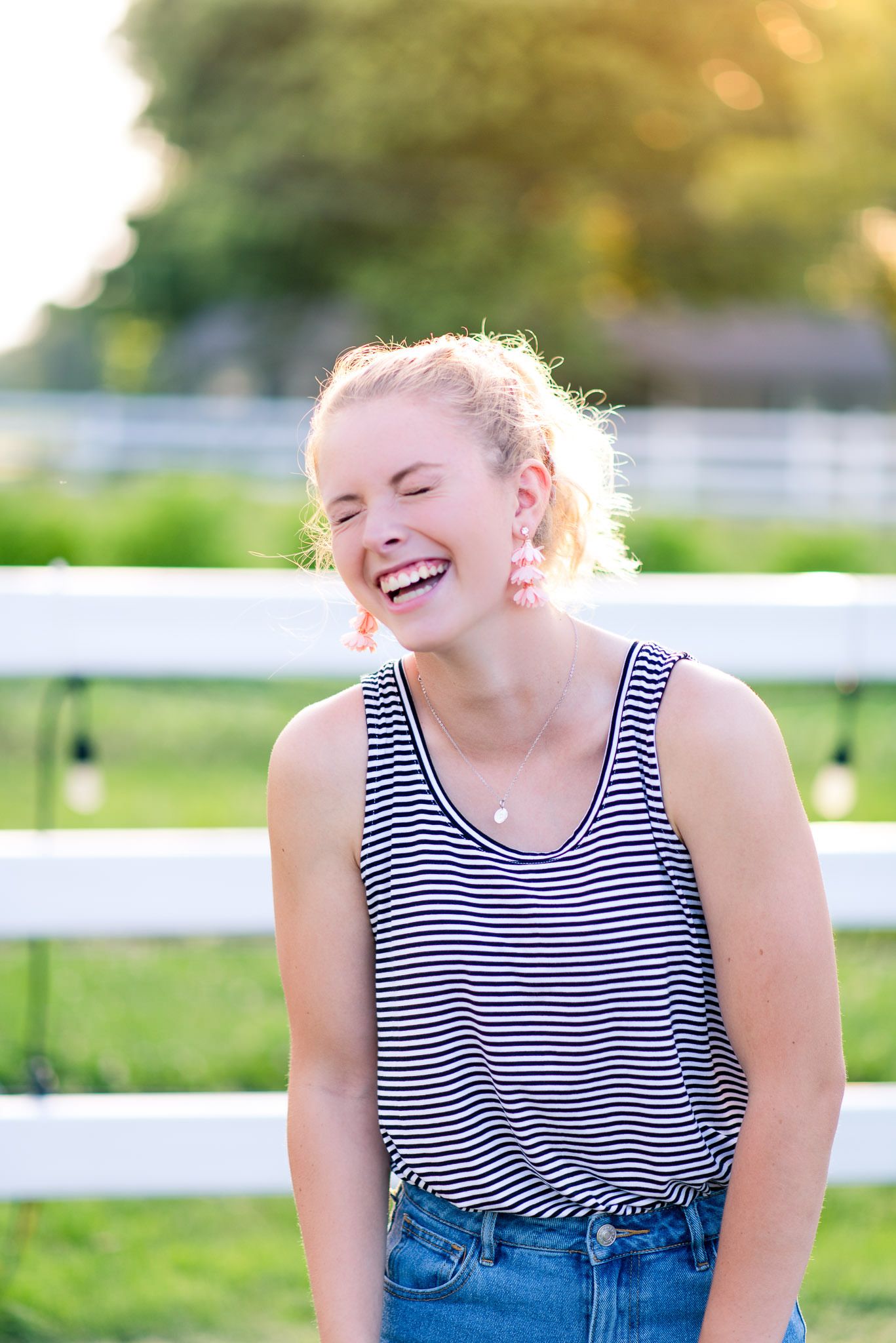 blonde woman with ponytail laughing with eyes closed at sunset the Marmalade Lily
