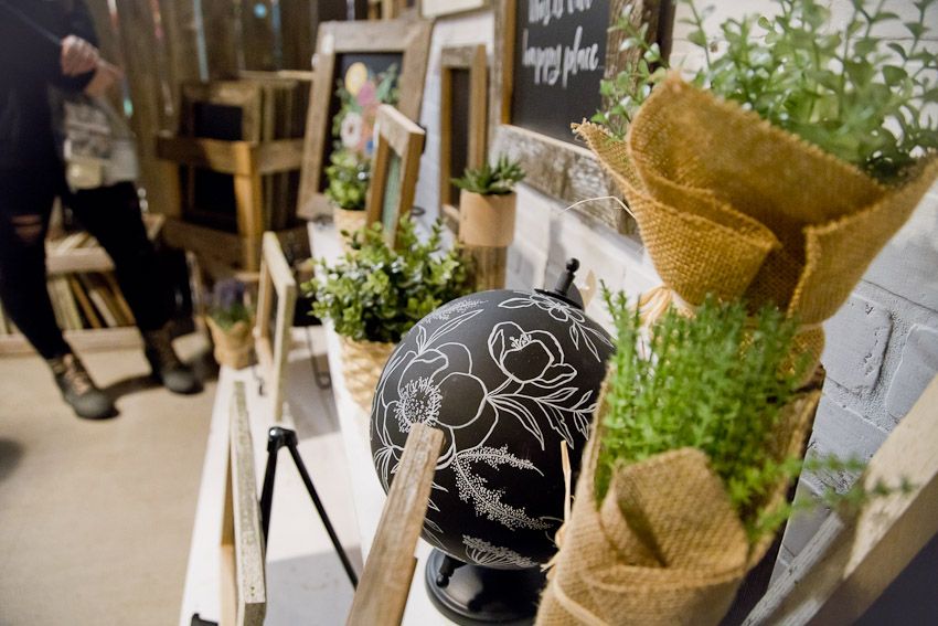 Pinolog Puyallup Something To Chalk About booth setup of potted plants and pre-made for sale items