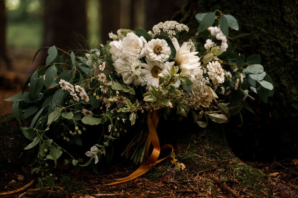 A white and green boho wedding bouquet for a Cornish woodland elopement.