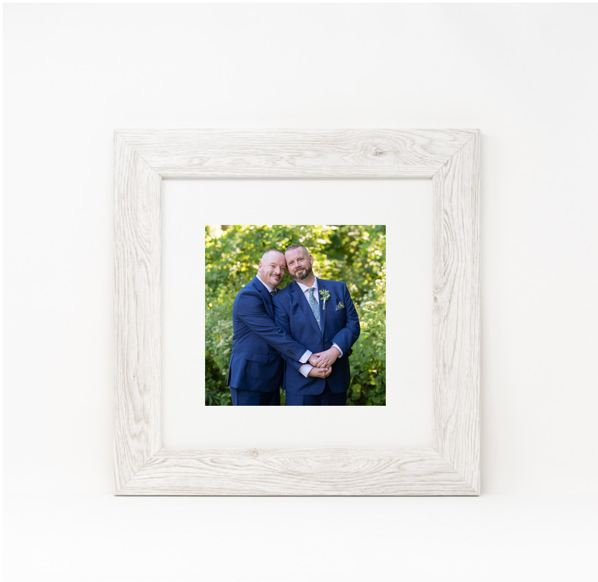 White weathered wooden picture frame displaying a photo against neutral background.