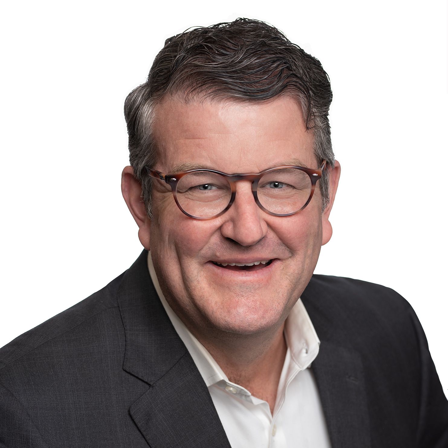 Professional headshot of businessman wearing glasses and dark suit jacket.