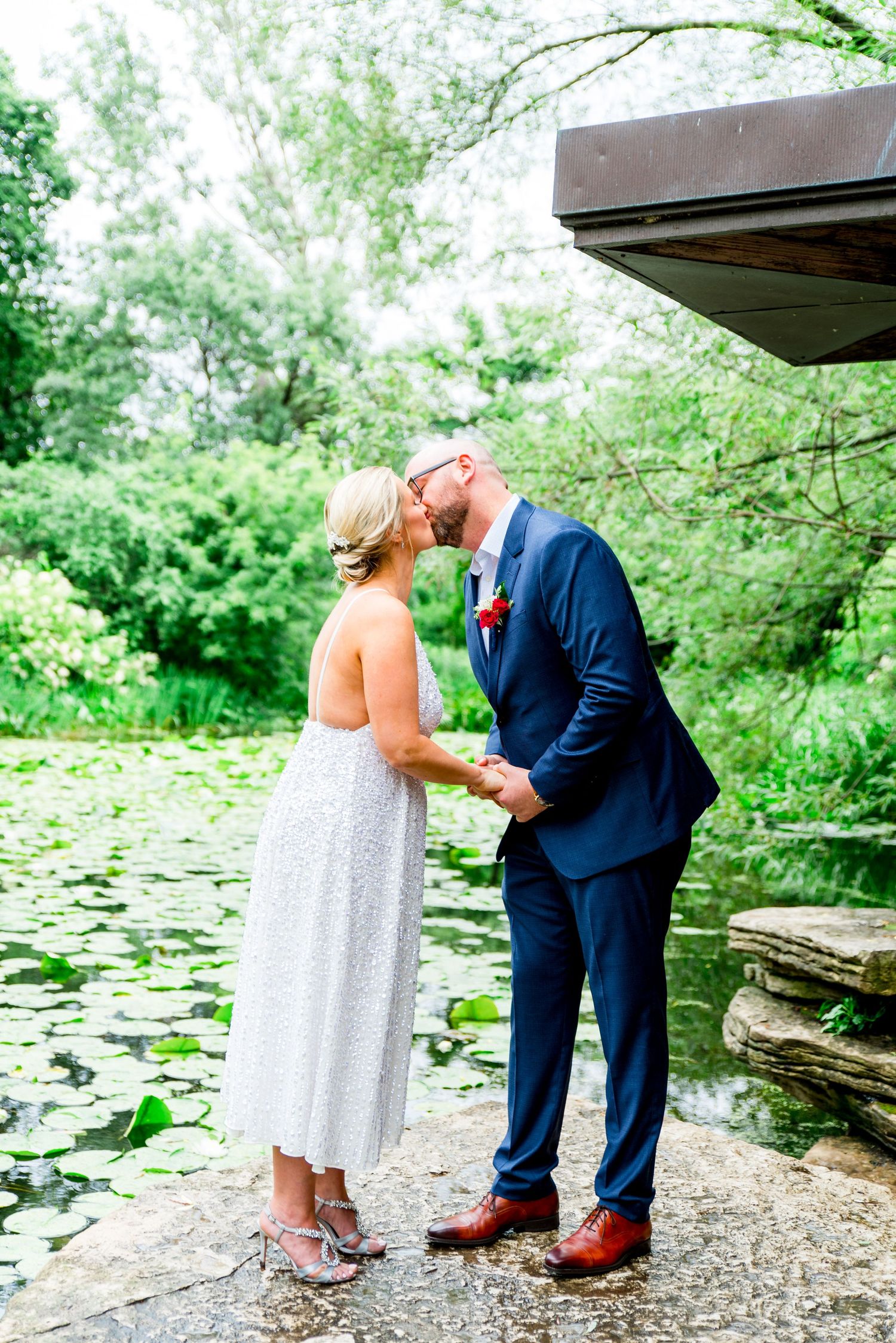 married couple kissing at Alfred Caldwell Lily Pool summer elopement
