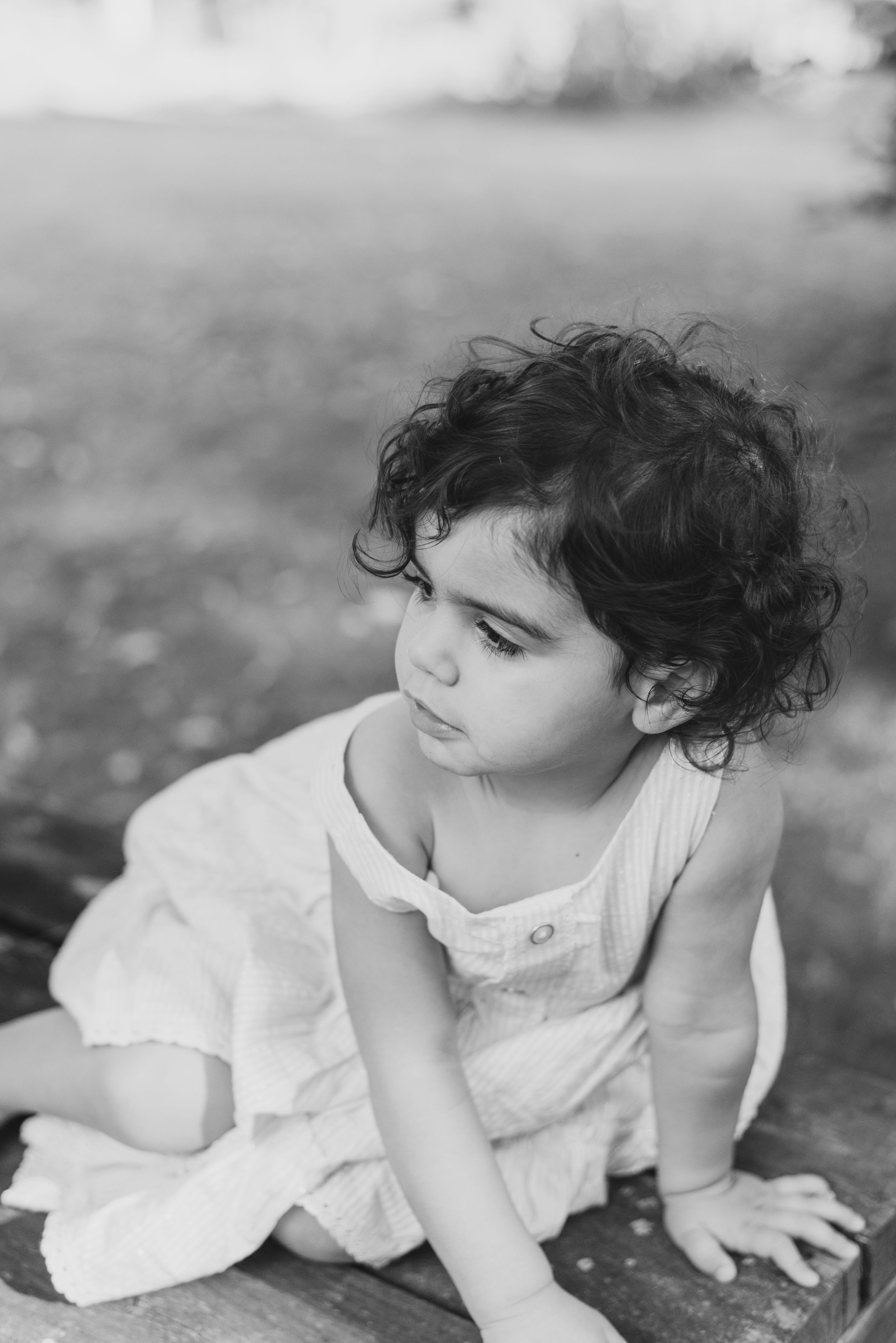 Toddler sitting in black and white in Pittsburgh, Pennsylvania