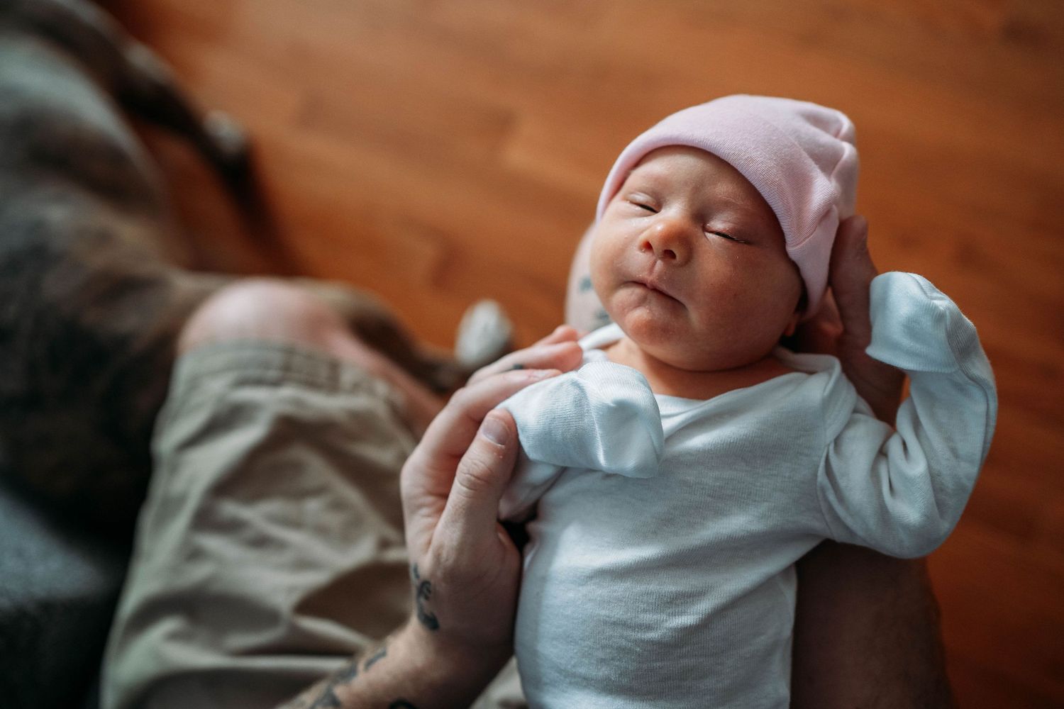 dad holding newborn baby in his arms in sudbury ma
