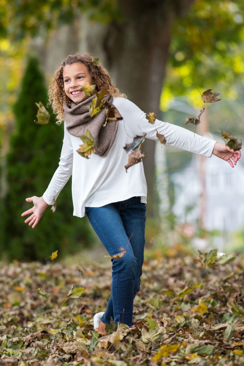 tween female model running through the leaves
