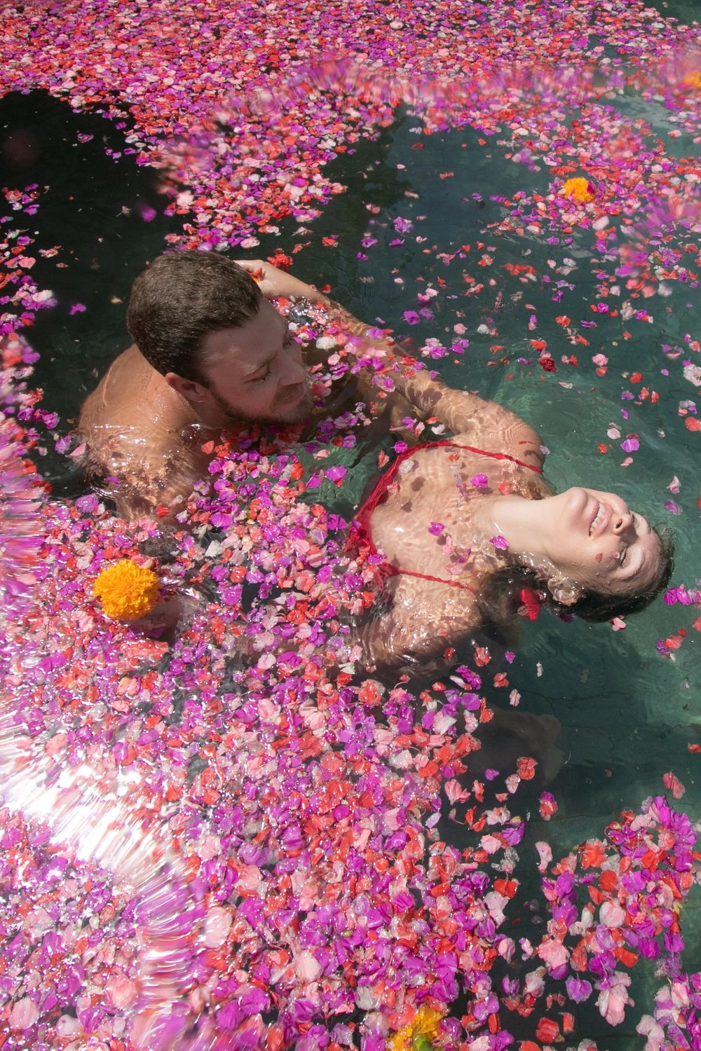 A couple in a pool of flowers