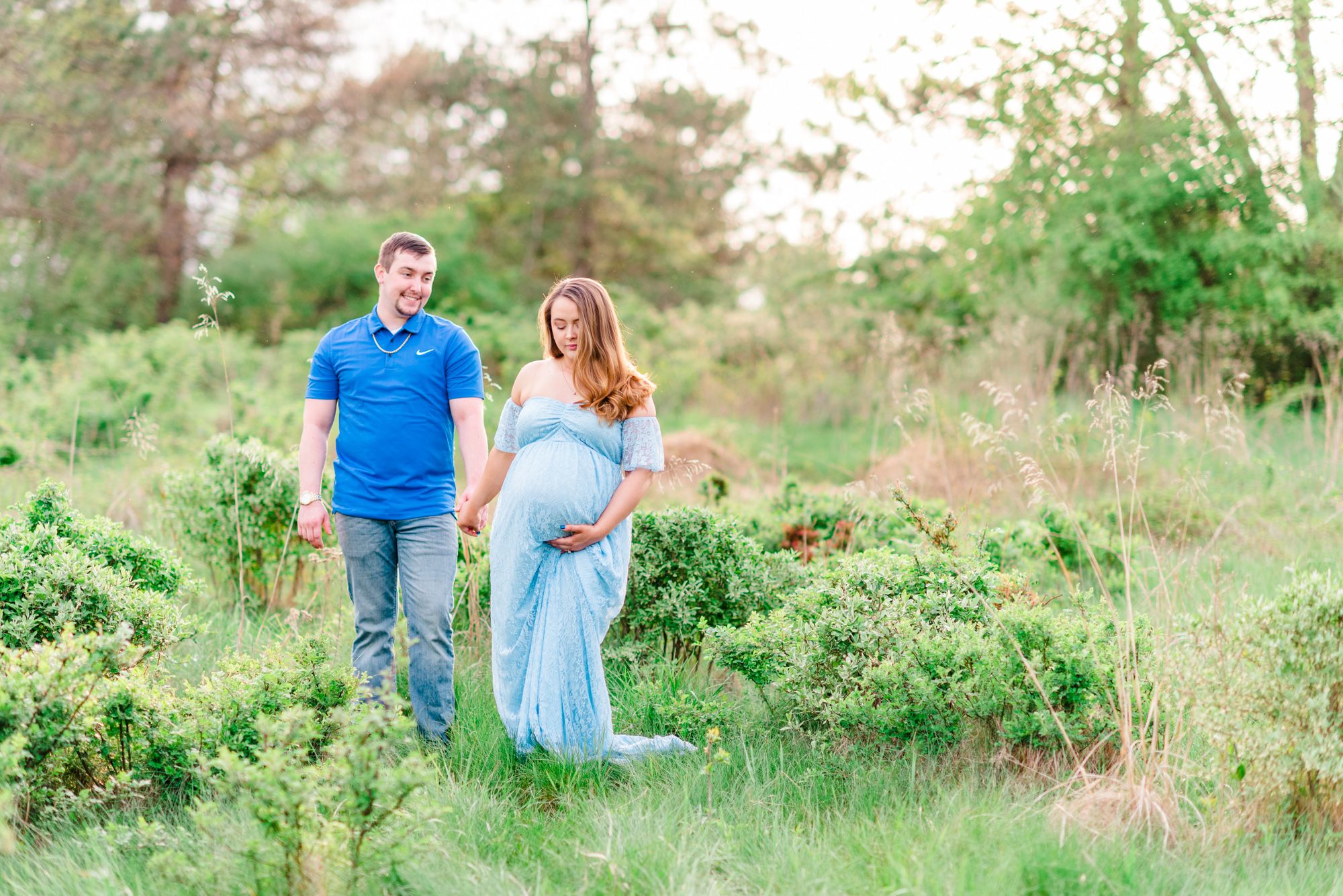 Maternity session with couple in field in golden hour sunlight at Moraine State Park, Pennsylvania