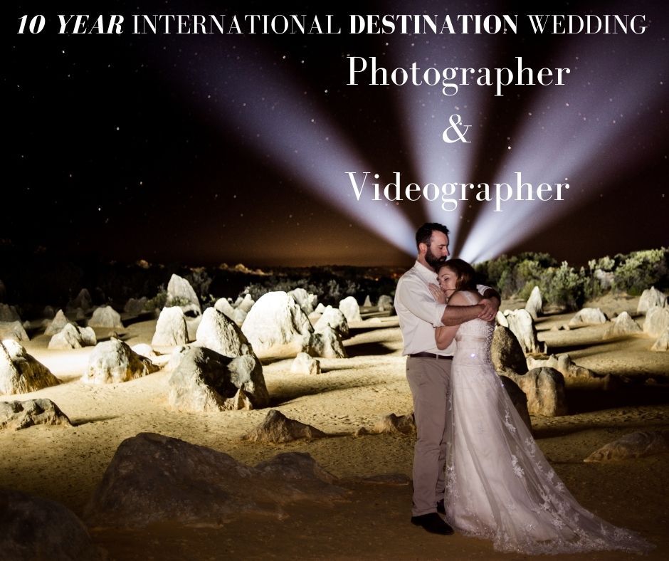 Dramatic nighttime wedding photo with light beams illuminating a rocky landscape.