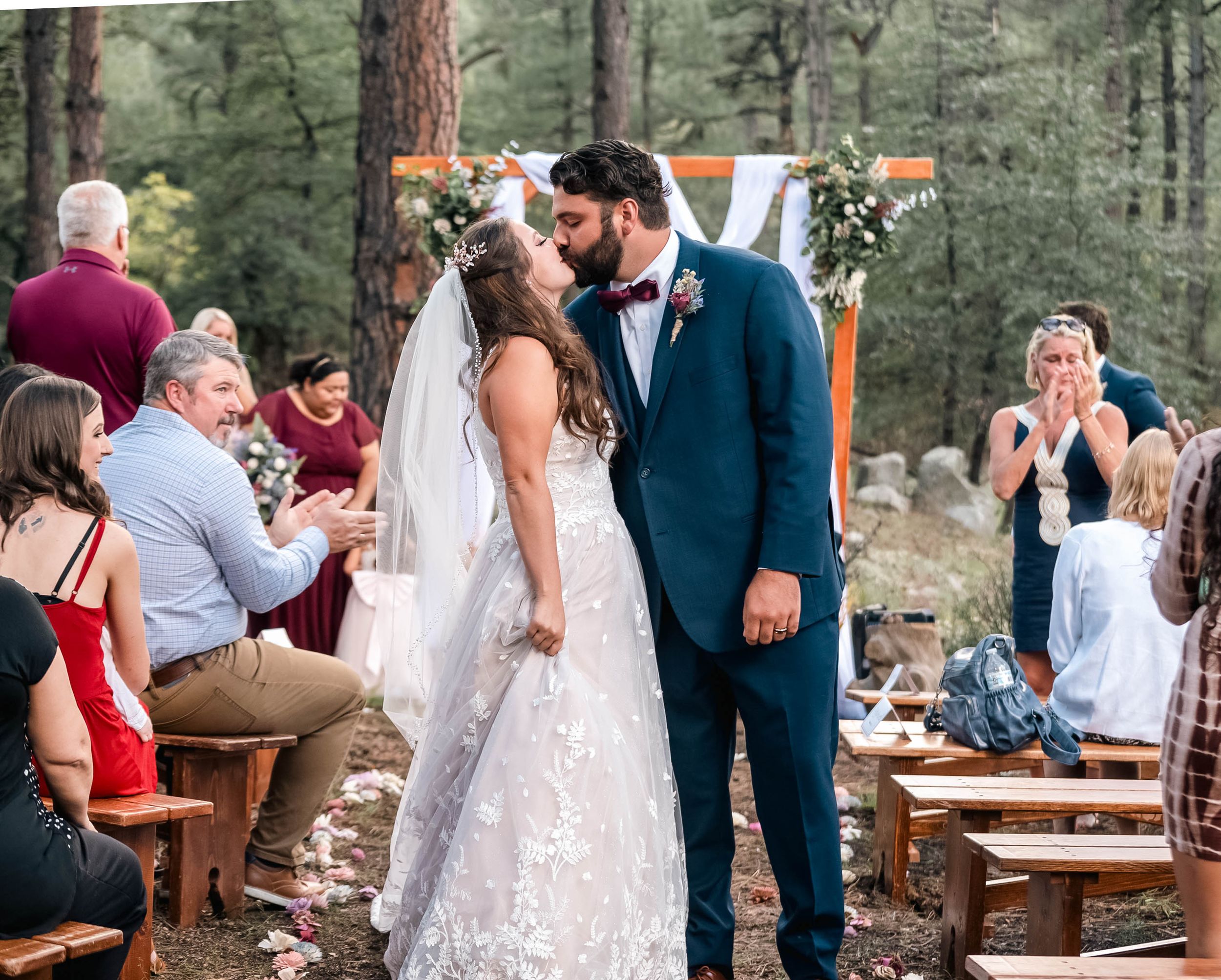Bride and groom share a sweet kiss down the Prescott, AZ aisle, marking the beginning of their beautiful journey.
