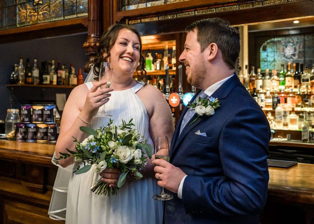 Newlyweds celebrate in bar at Storrs Hall by Windermere