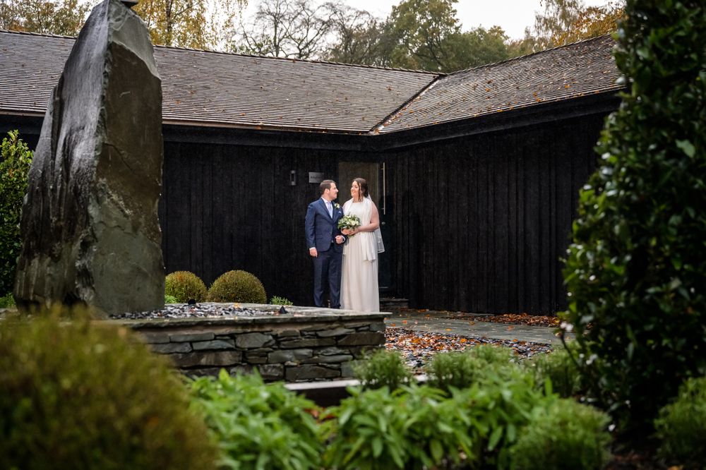 Newlyweds outside lakeside lodges at Storrs Hall