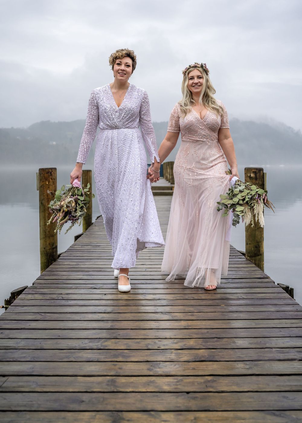 Same sex couple walking along jetty at Storrs Hall