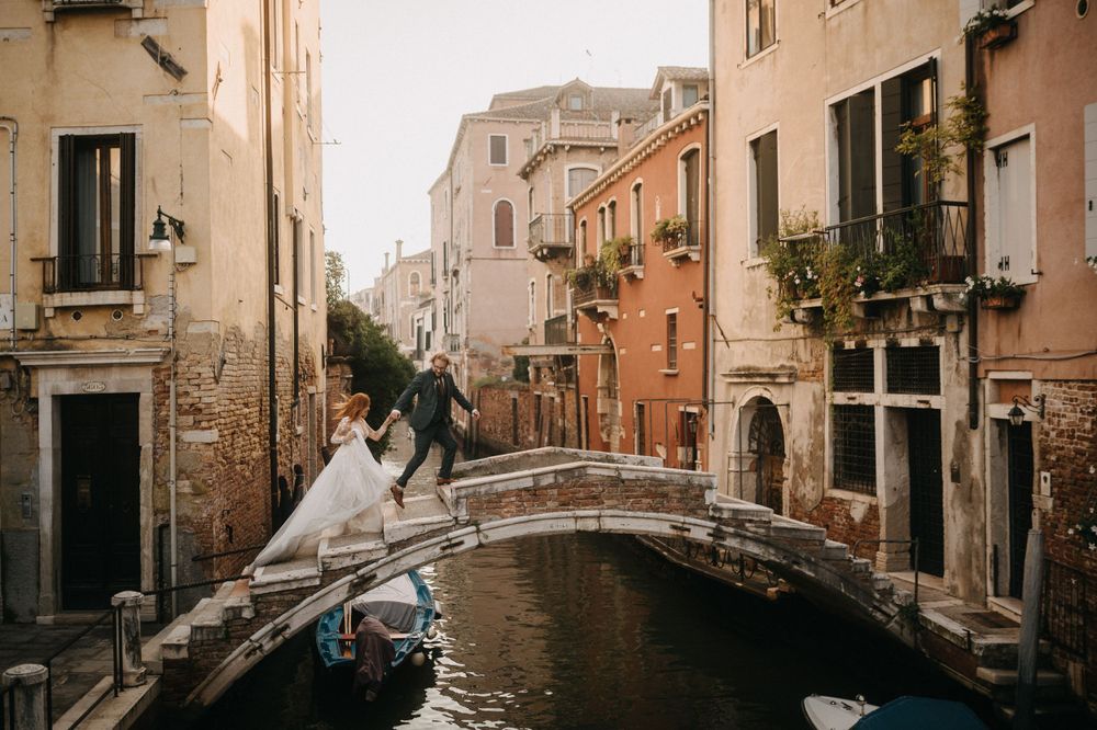 A panoramic view of a picturesque Venice canal with traditional architecture and bridges.