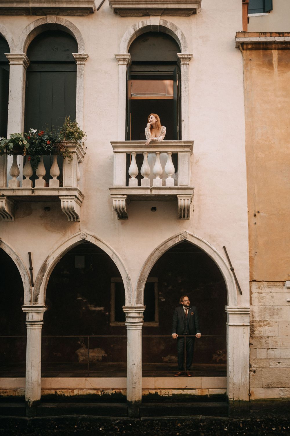 Classic Venetian architecture featuring arched windows and ornate stonework along the canal.