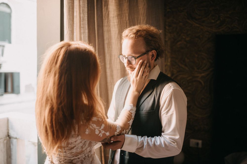 Intimate indoor portrait session with dramatic shadows and window light.