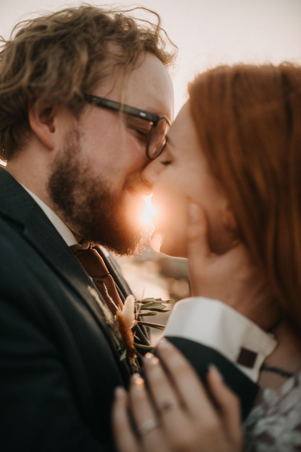 Intimate sunset portrait of newlyweds sharing a tender moment in Venice.