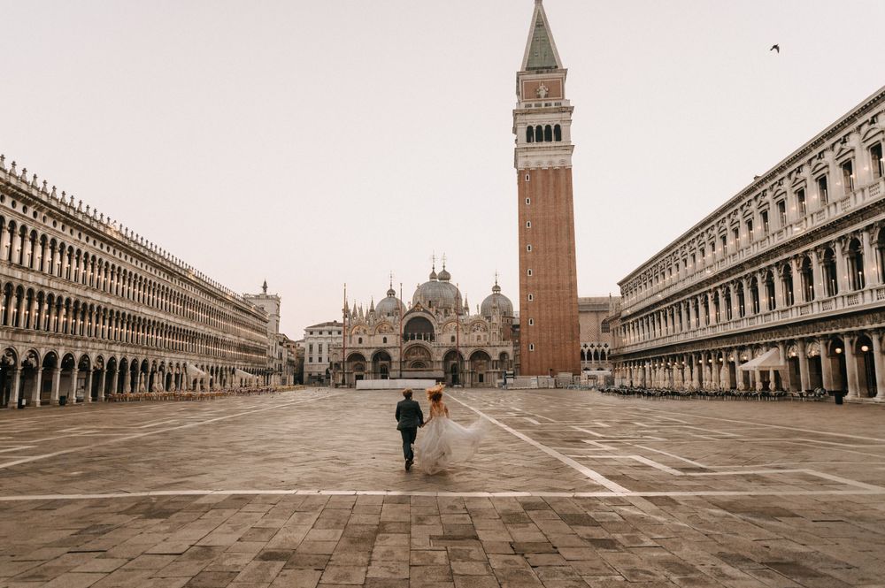 Panoramic view of St Mark's Square in Venice with historic architecture and campanile.